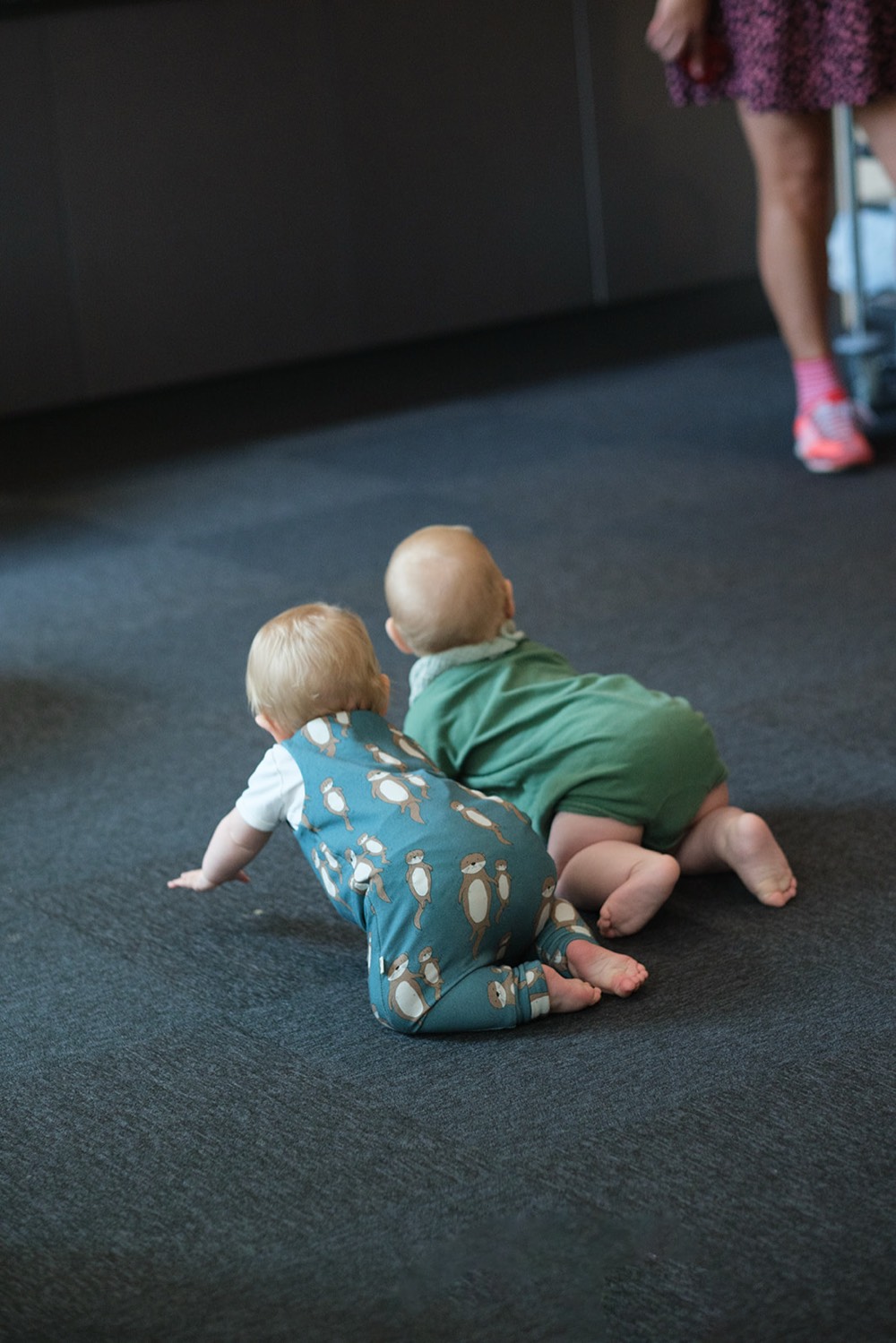 Two babies crawling across the room at the pilot