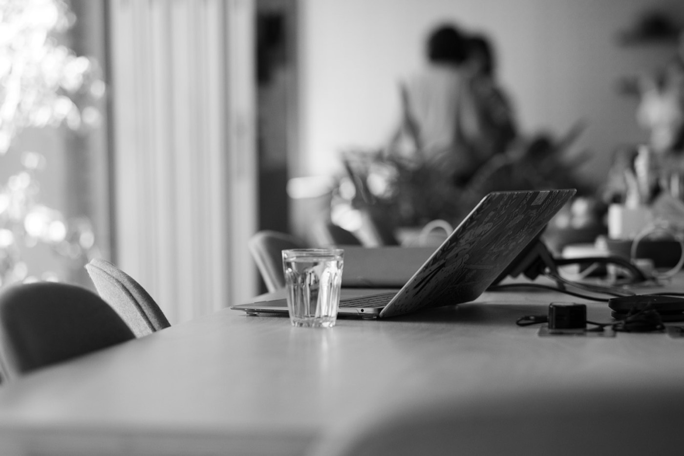 A laptop and water glass on the workshop bench at the pilot