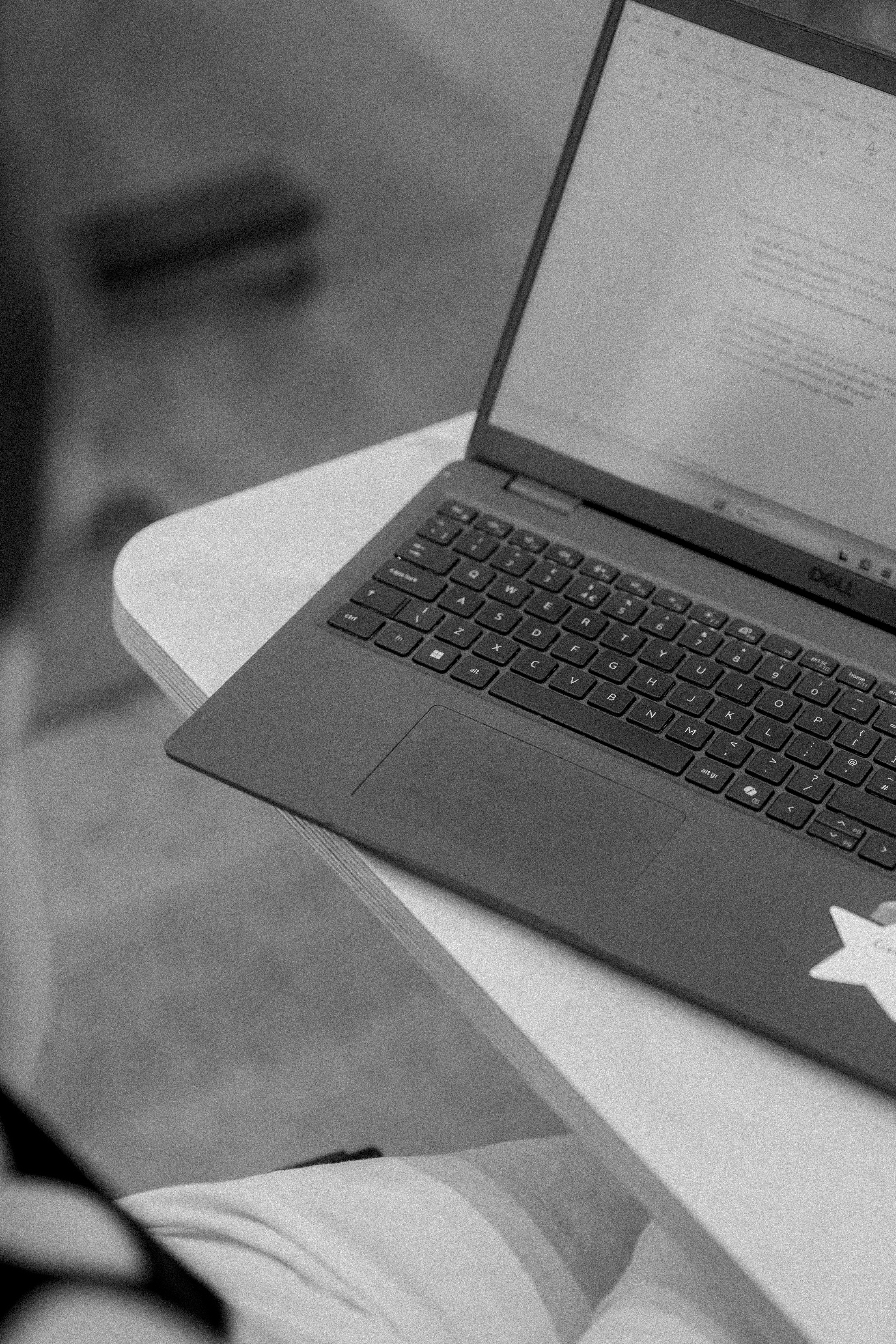 A mum working on a laptop, preparing to ask her employer to fund the programme